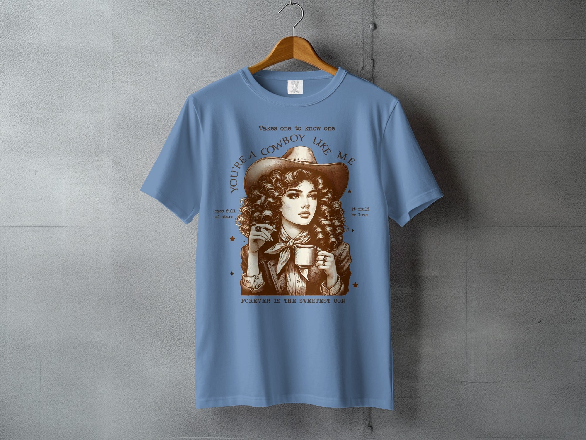 Blue t-shirt with cowgirl graphic and text "You're a cowboy like me".