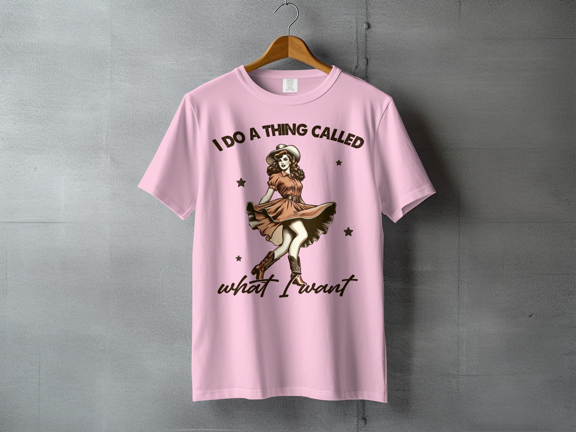 Pink t-shirt with cowgirl graphic and text "I DO A THING CALLED what I want".