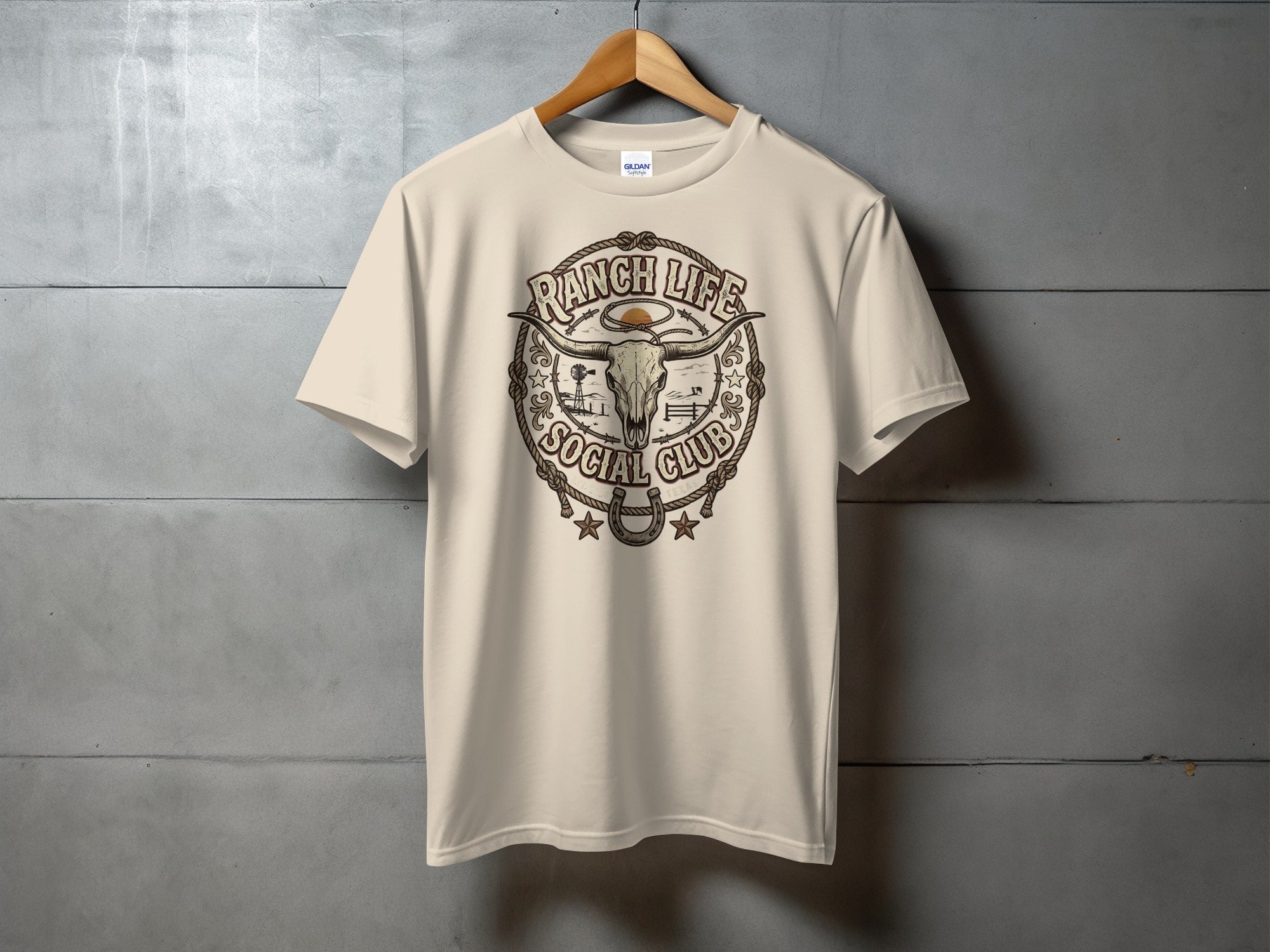 Tan t-shirt with "Ranch Life Social Club" graphic featuring a bull skull and rope.