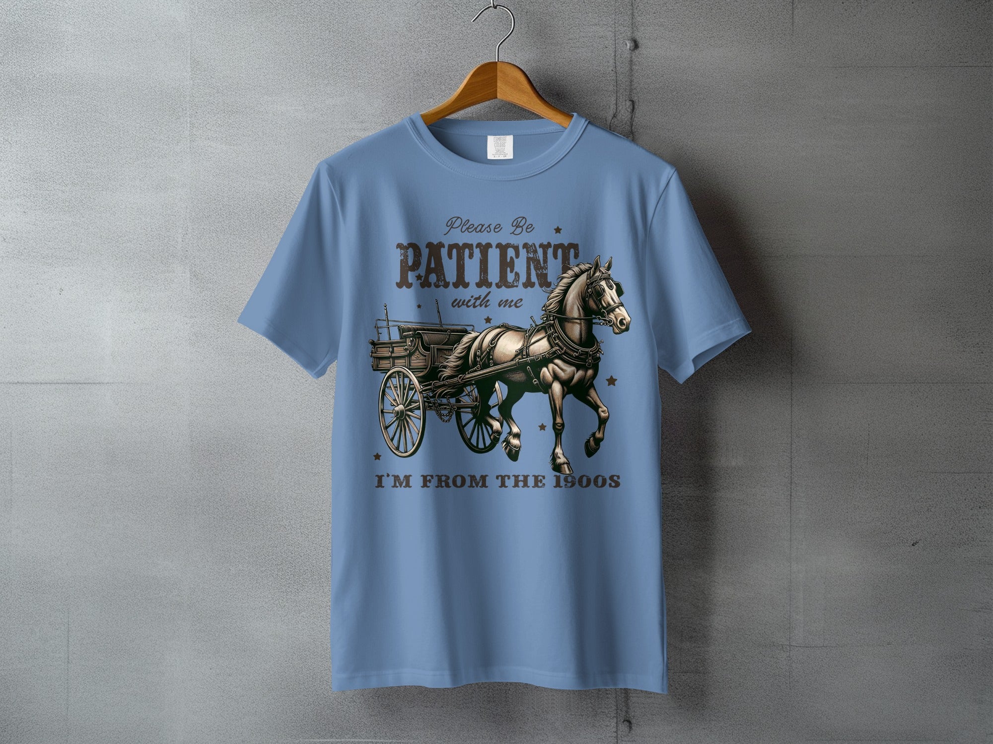 T-shirt with horse and carriage graphic and text "Please be patient with me I'm from the 1900s".