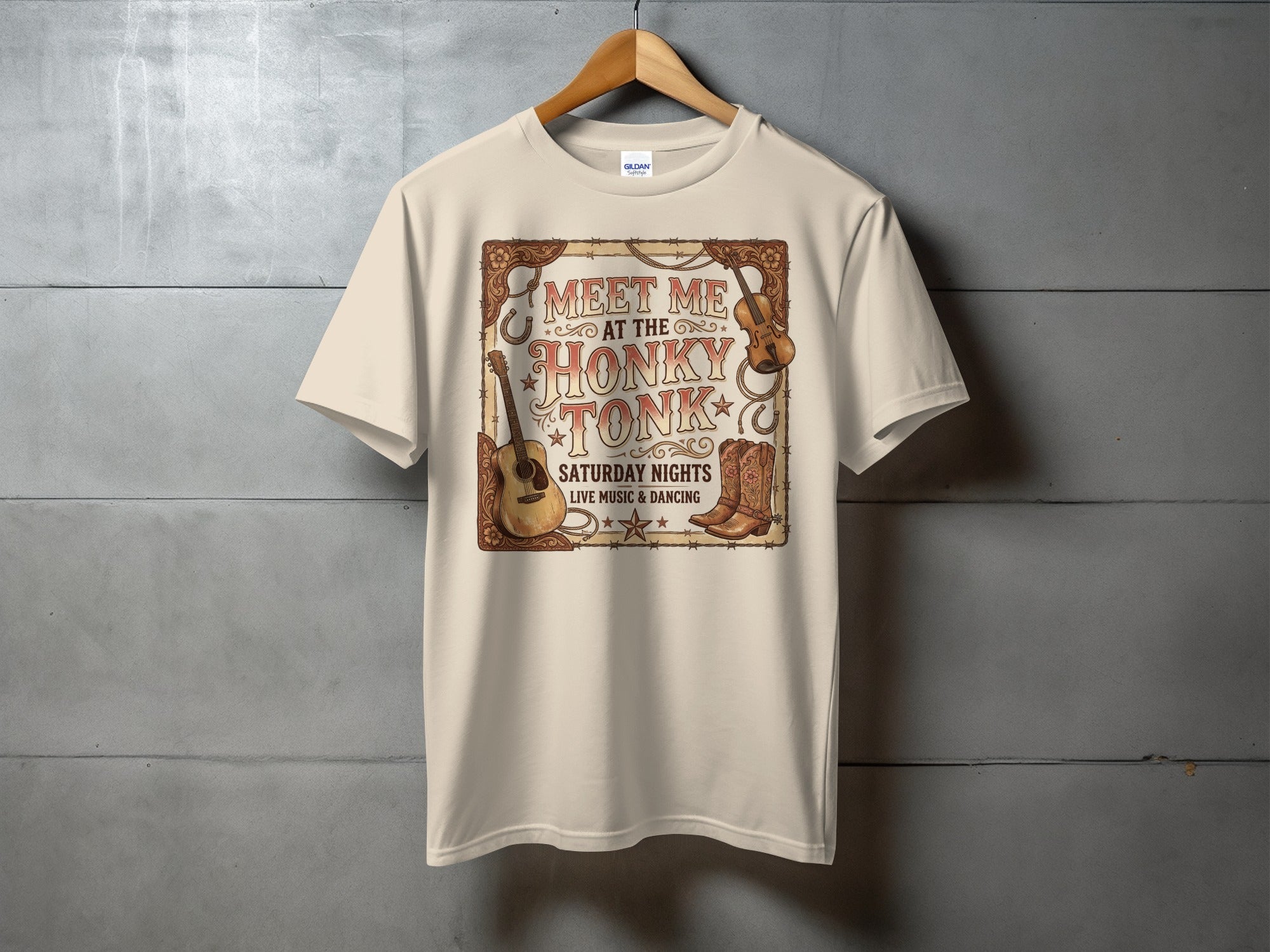Tan t-shirt with "Meet Me at the Honky Tonk" graphic, featuring guitars and boots.
