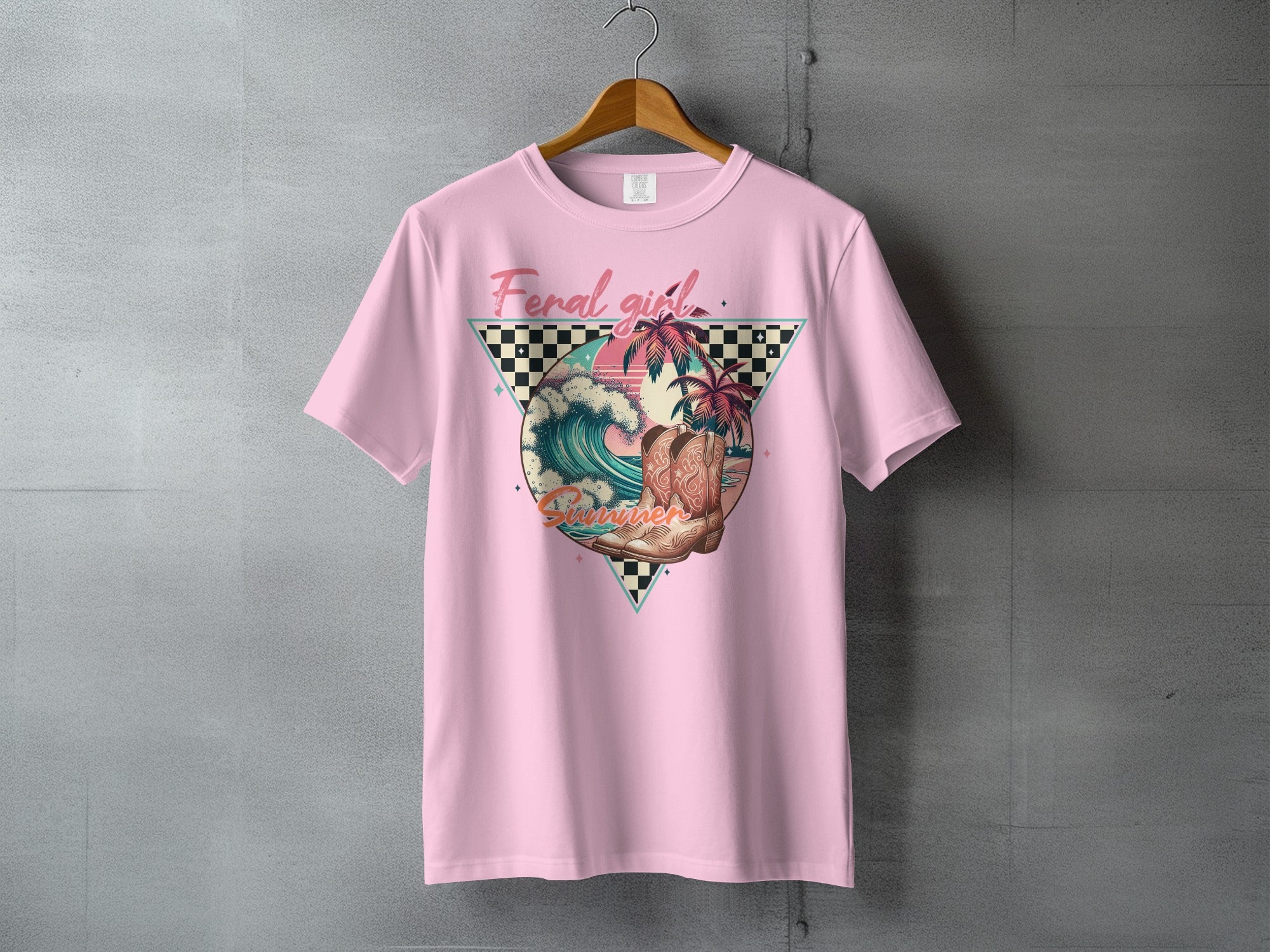 Pink t-shirt with "Feral girl Summer" graphic featuring cowboy boot, palm trees, and waves.