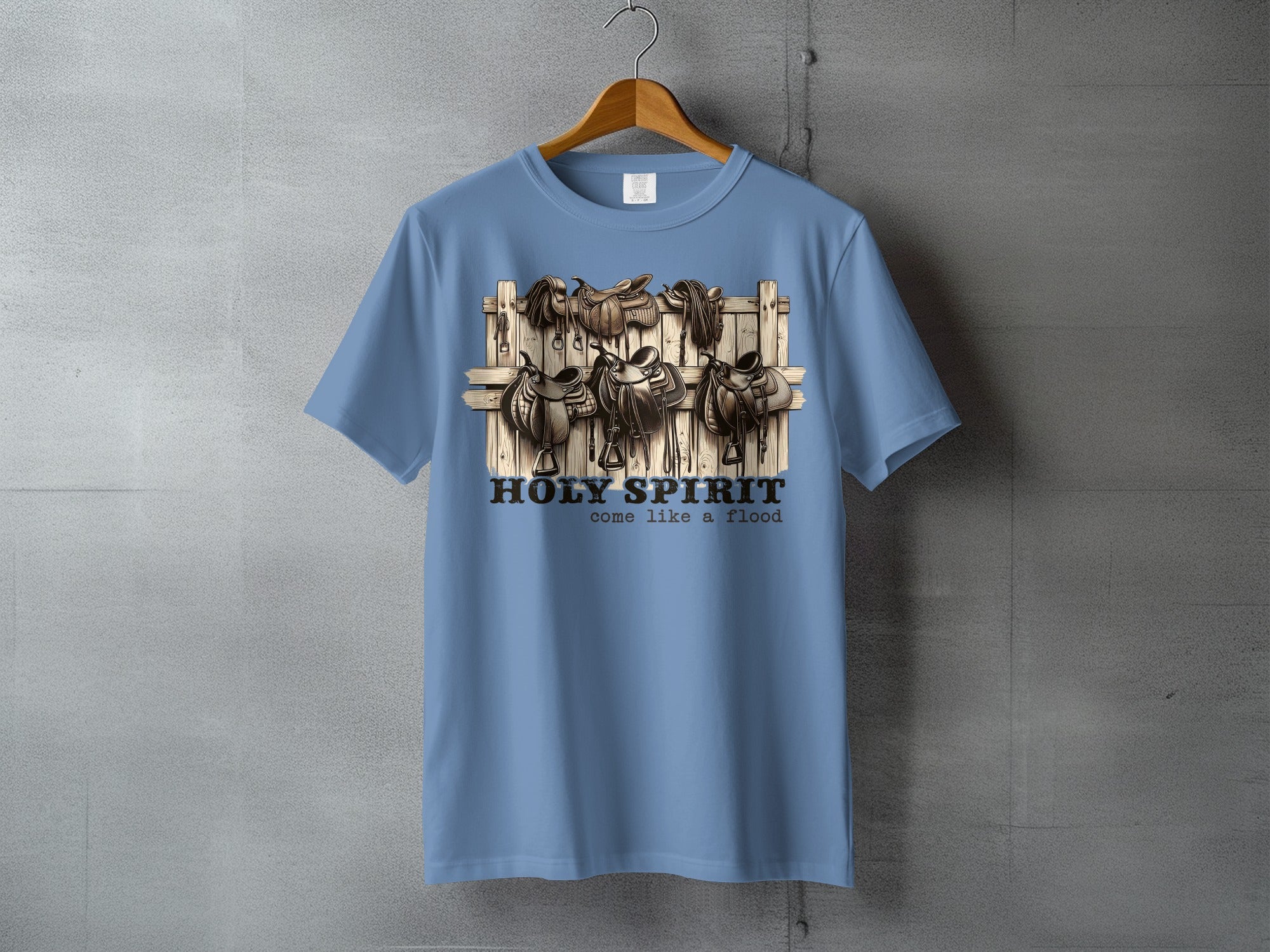Blue t-shirt with "HOLY SPIRIT come like a flood" and saddles graphic.