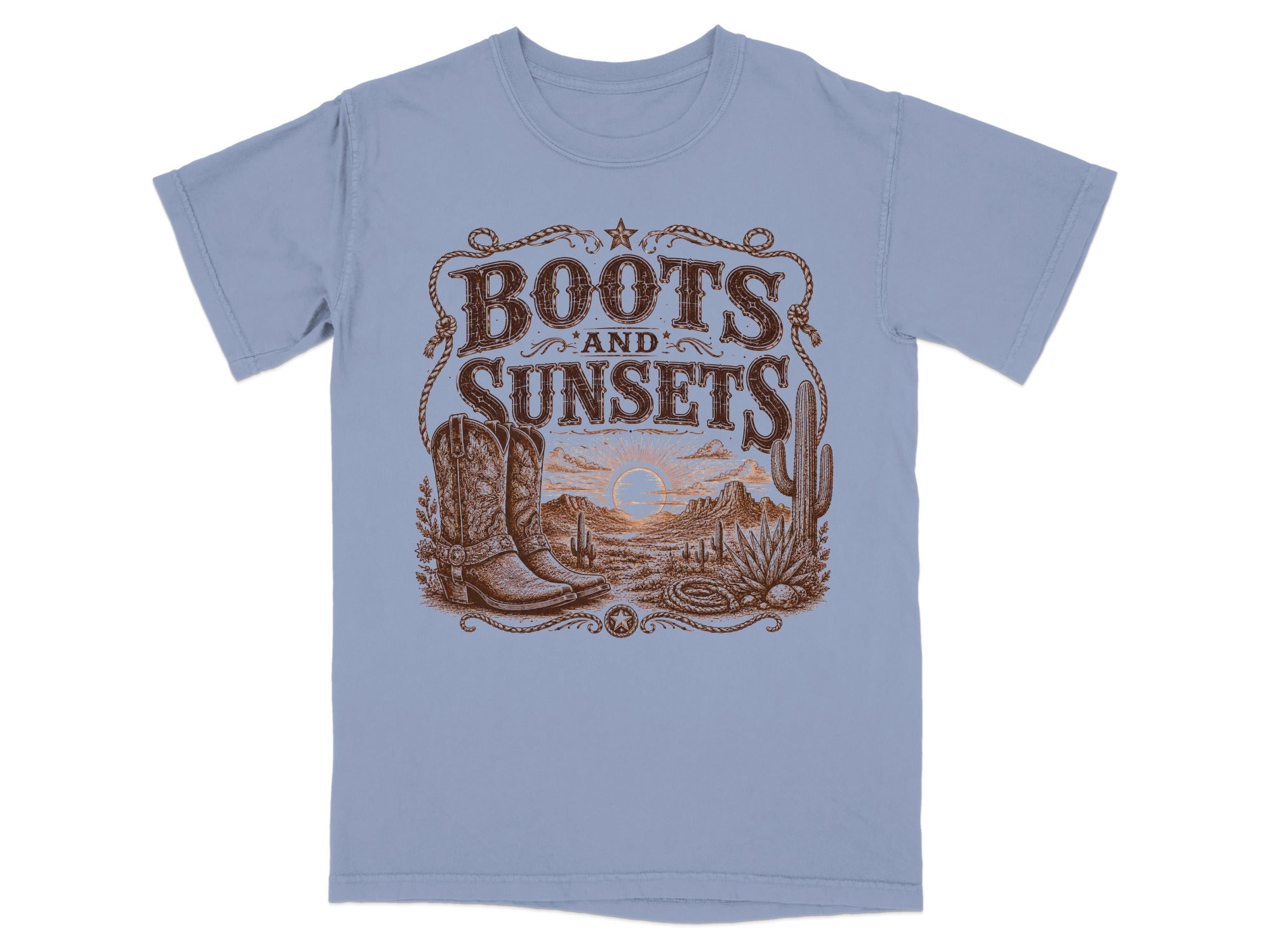 Boots and Sunsets graphic on a light blue t-shirt with desert landscape and cowboy boots.