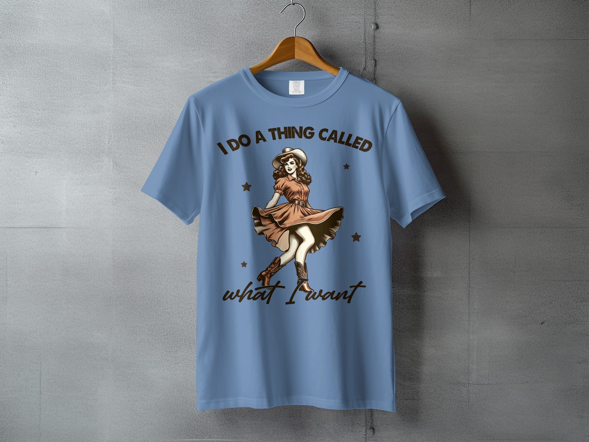 Blue t-shirt with "I DO A THING CALLED what I want" and retro cowgirl graphic.