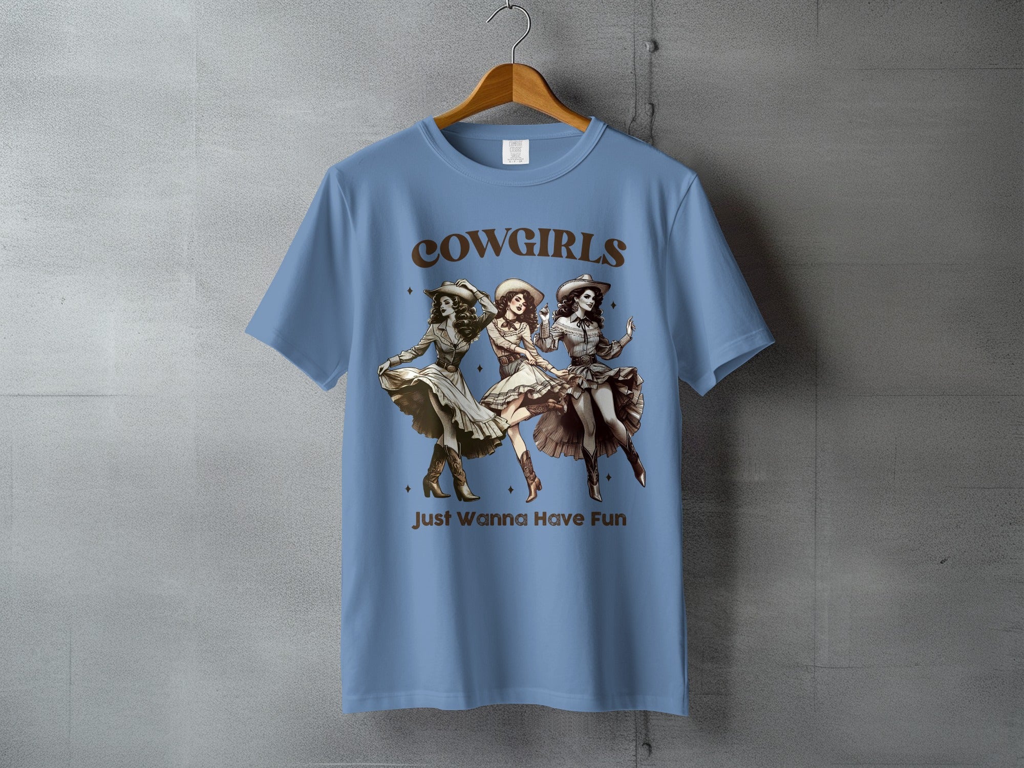 Cowgirls Just Wanna Have Fun graphic tee with three dancing cowgirls.