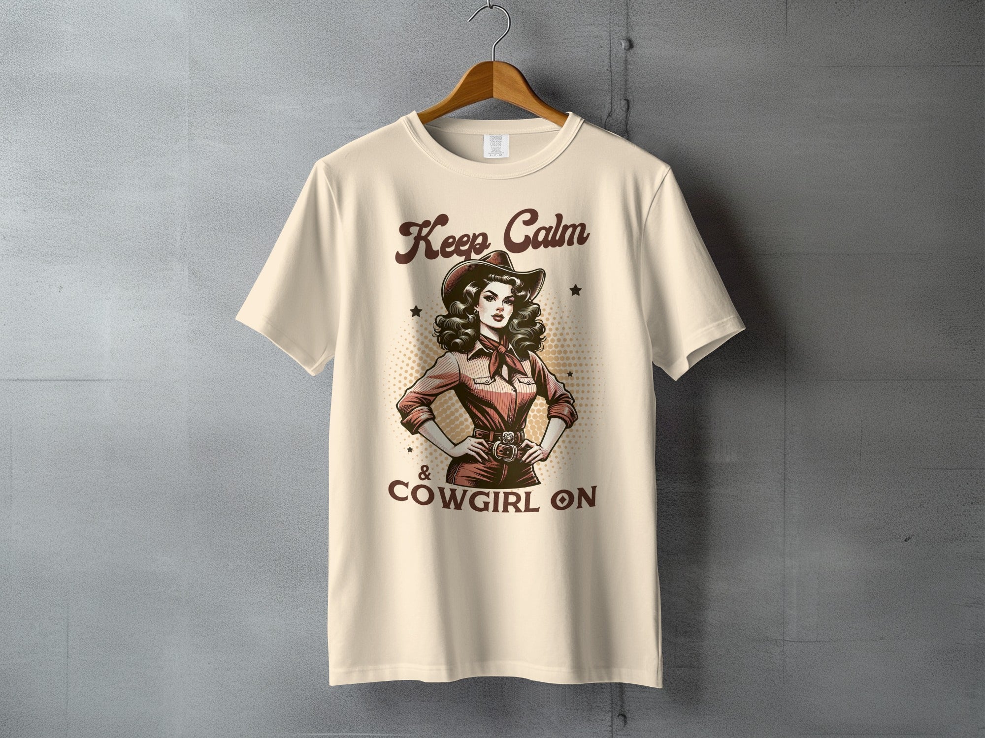 Cream t-shirt with "Keep Calm & Cowgirl On" text and a woman in a cowboy hat.