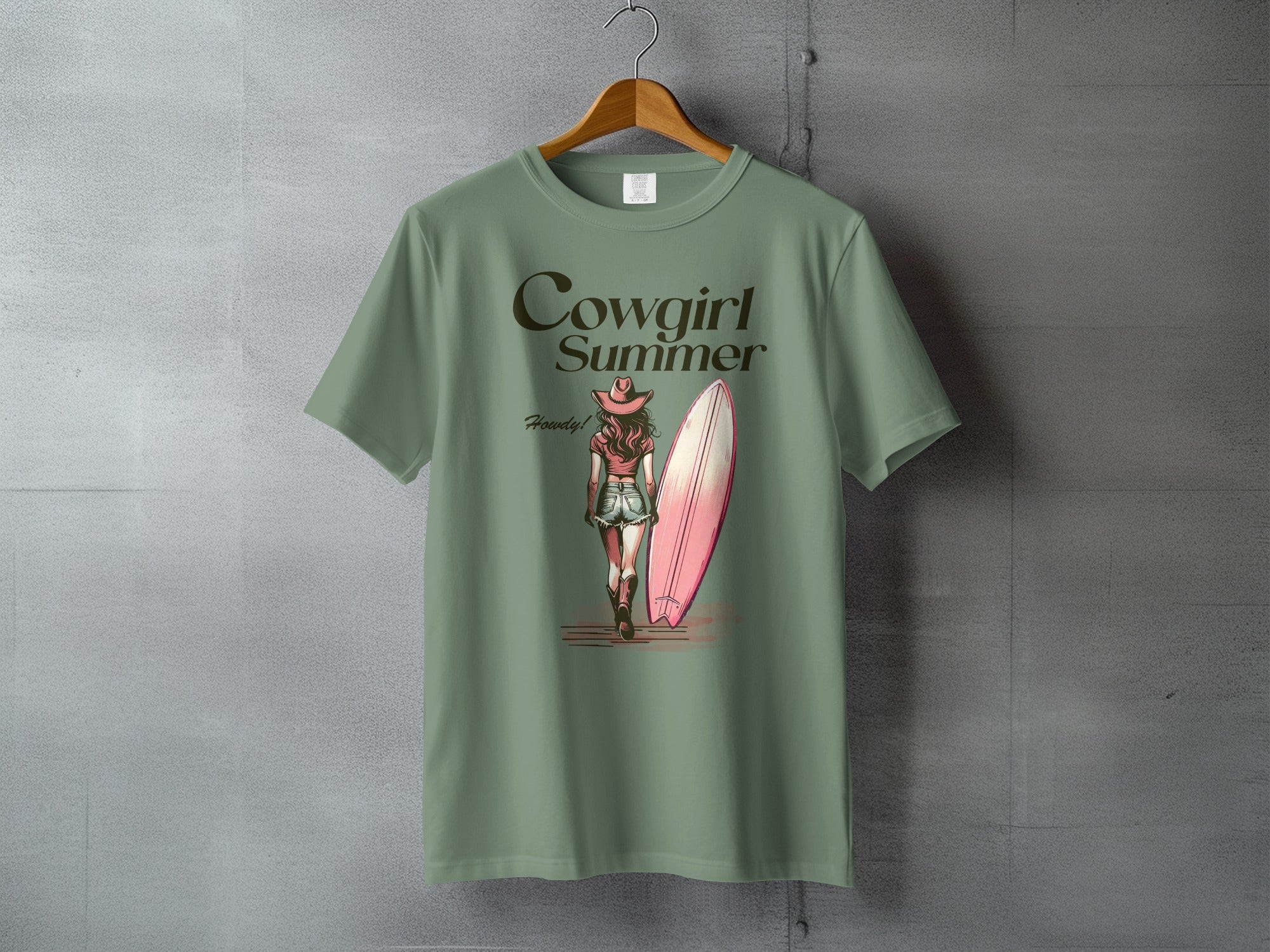 Green t-shirt with "Cowgirl Summer" and a surfer girl with a surfboard.