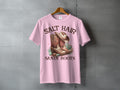 Pink t-shirt with cowboy boots, hat, and seashells, text reads SALT HAIR SANDY BOOTS.