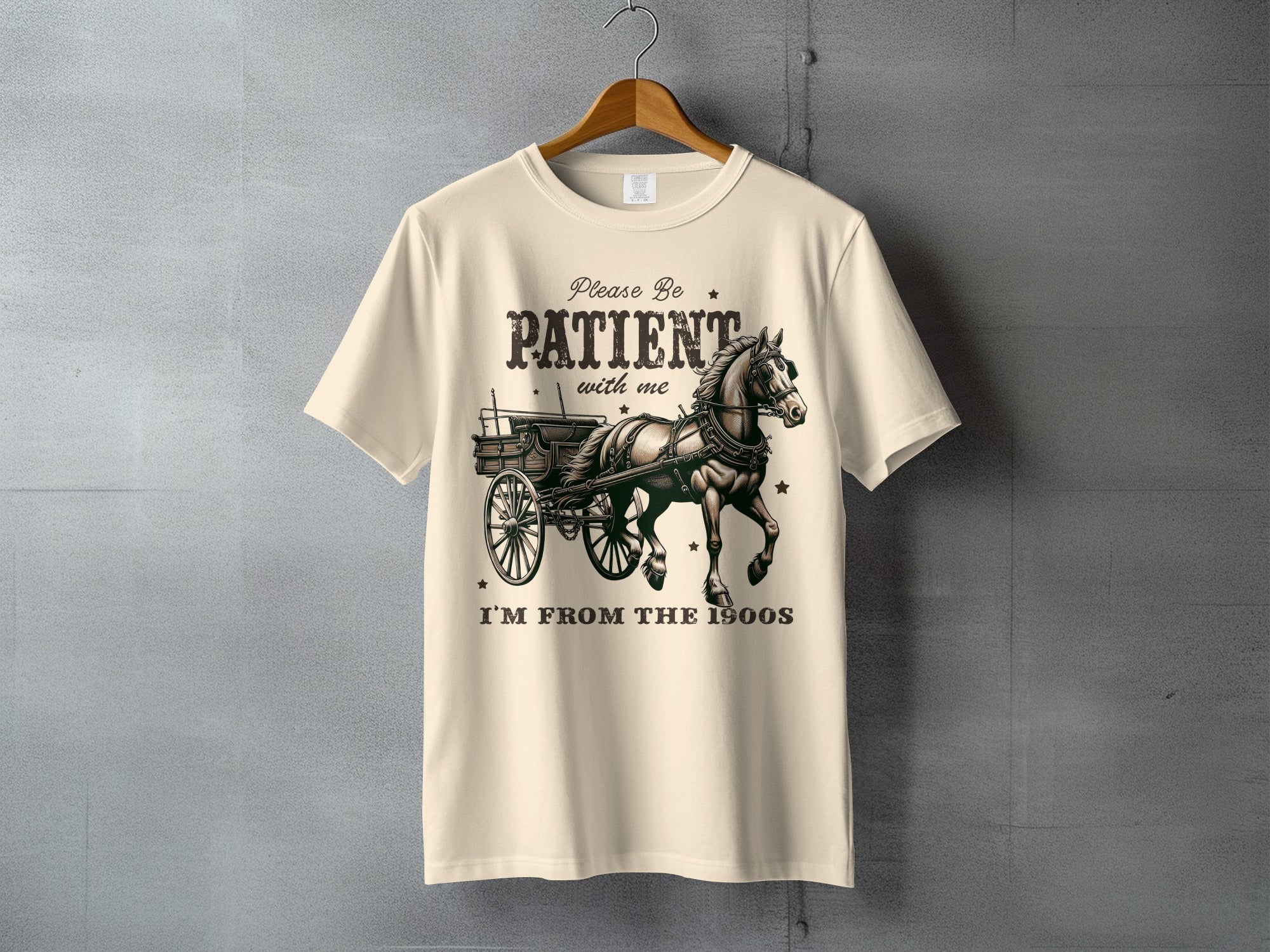 Cream t-shirt with horse and carriage graphic and text "Please be patient with me I'm from the 1900s".