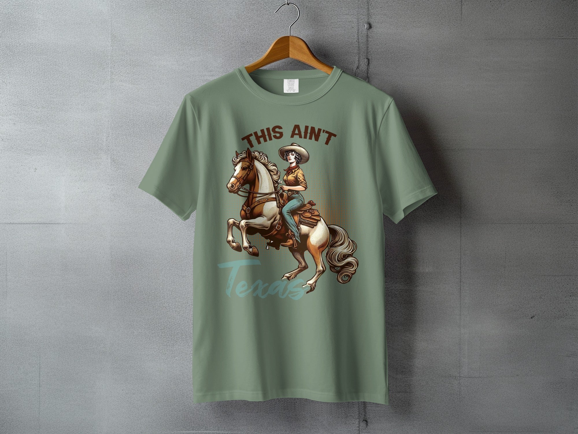 T-shirt with graphic of woman riding horse, "This Ain't Texas" text.
