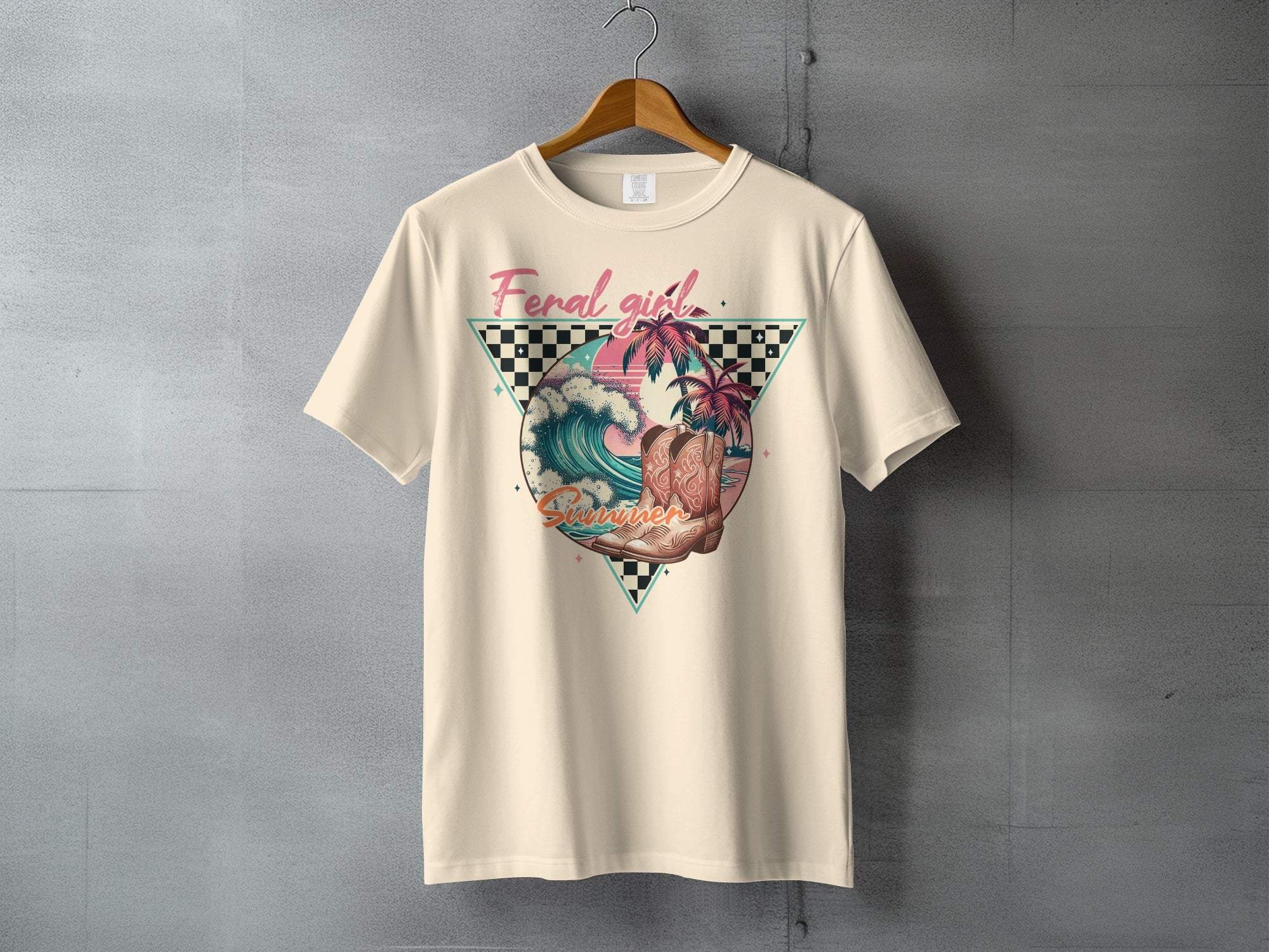 Beige t-shirt with "Feral Girl Summer" text and retro beach scene graphic.