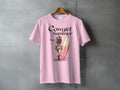 Pink t-shirt with "Cowgirl Summer" text and woman with surfboard illustration.