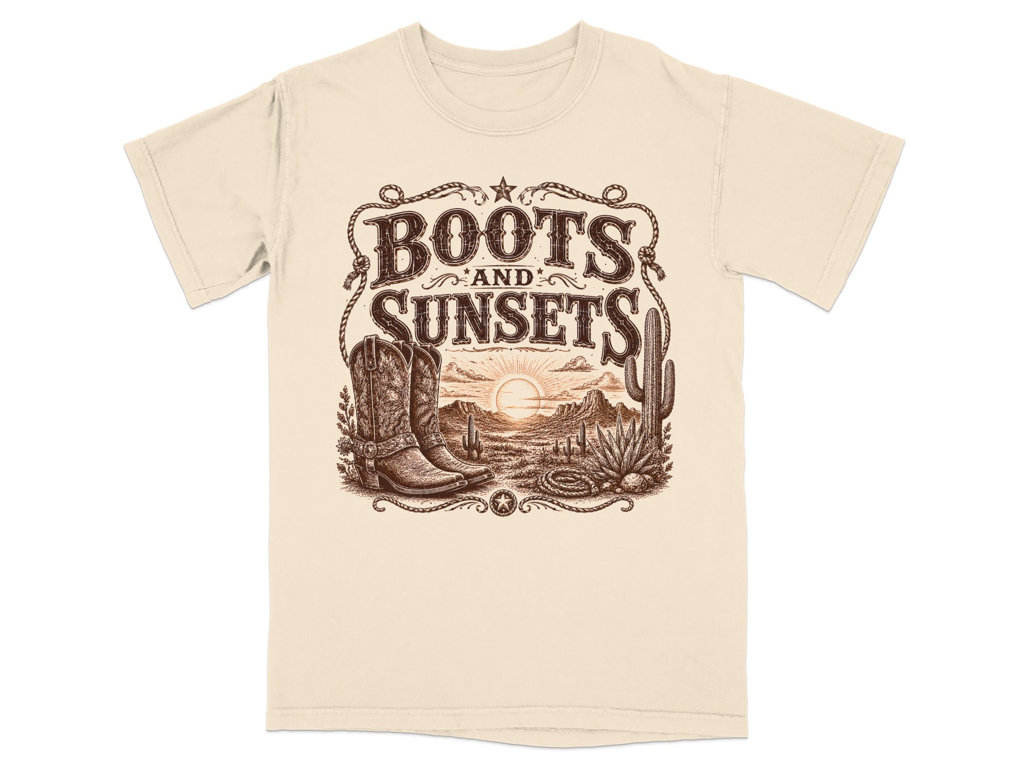 Cream t-shirt with "Boots and Sunsets" graphic featuring cowboy boots and desert landscape.