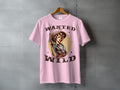 Pink t-shirt graphic: Woman in cowboy hat and Western wear holding a pistol, "Wanted and Wild".