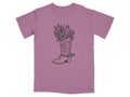 Cowboy boot with flowers and cactus graphic on a mauve t-shirt.