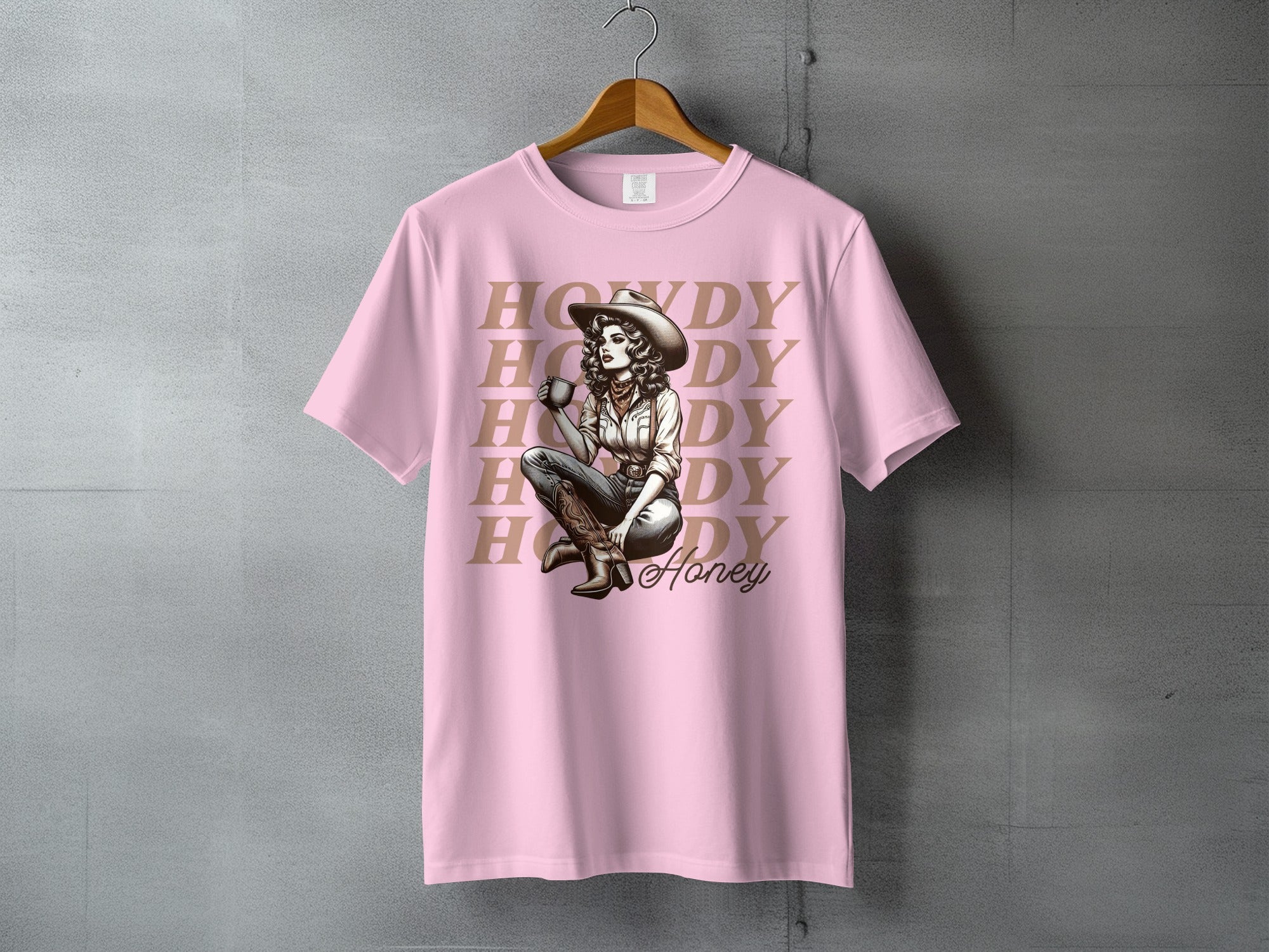 Pink t-shirt with "Howdy Honey" text and woman in cowboy hat.