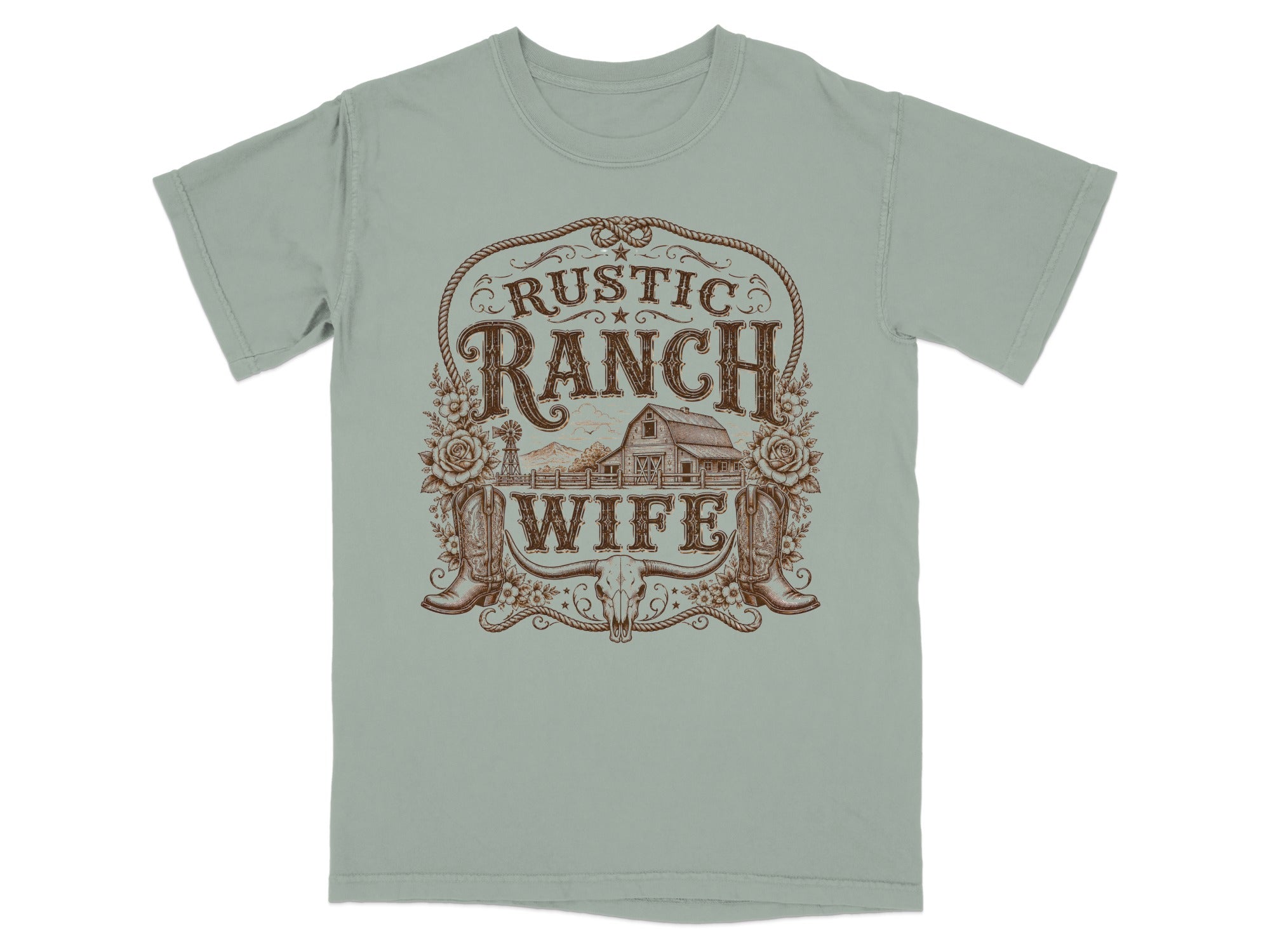 T-shirt with a rustic ranch wife design featuring a barn, boots, flowers, and bull skull.