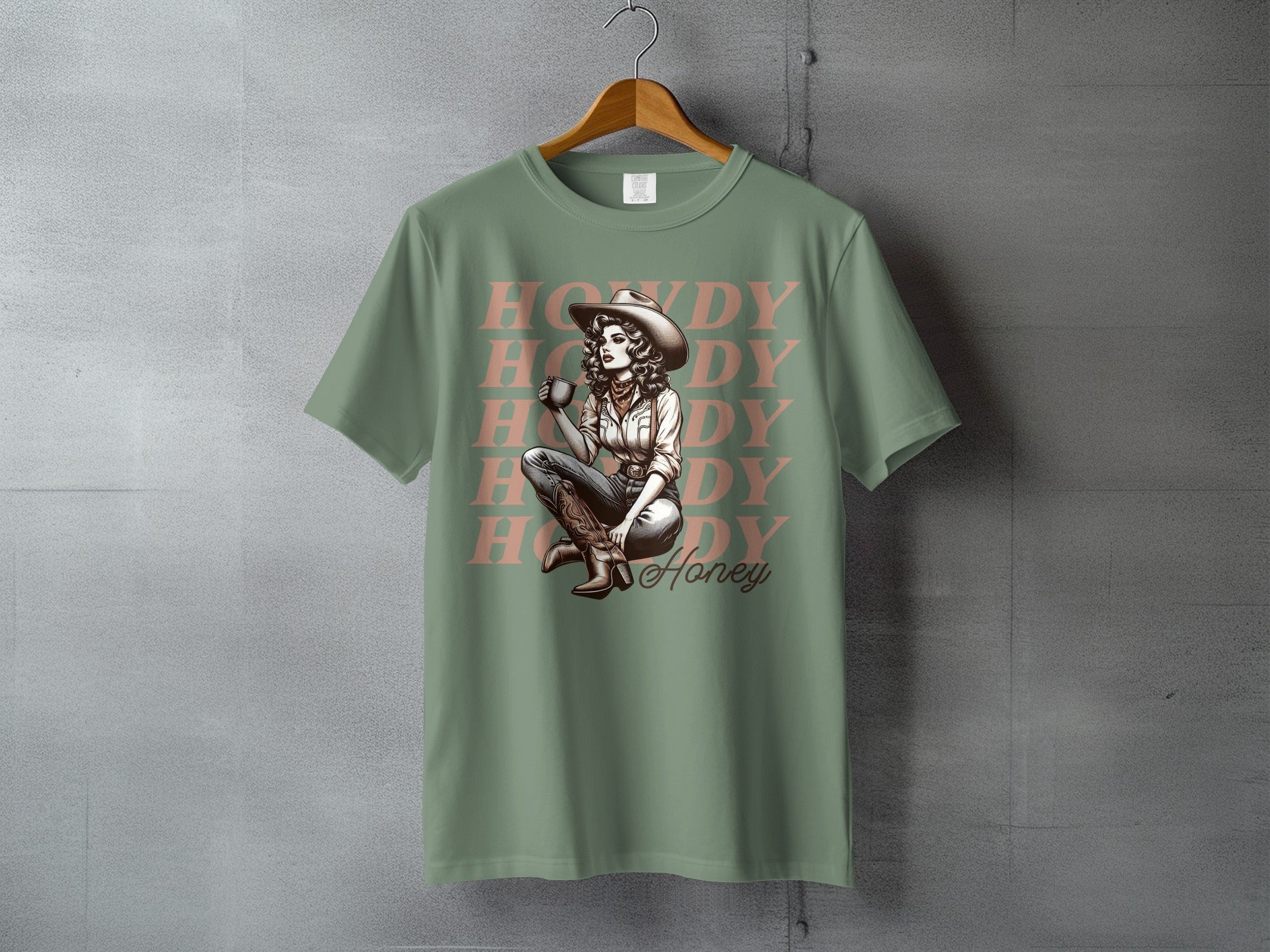 Green t-shirt with distressed "Howdy Honey" text and illustration of a woman.