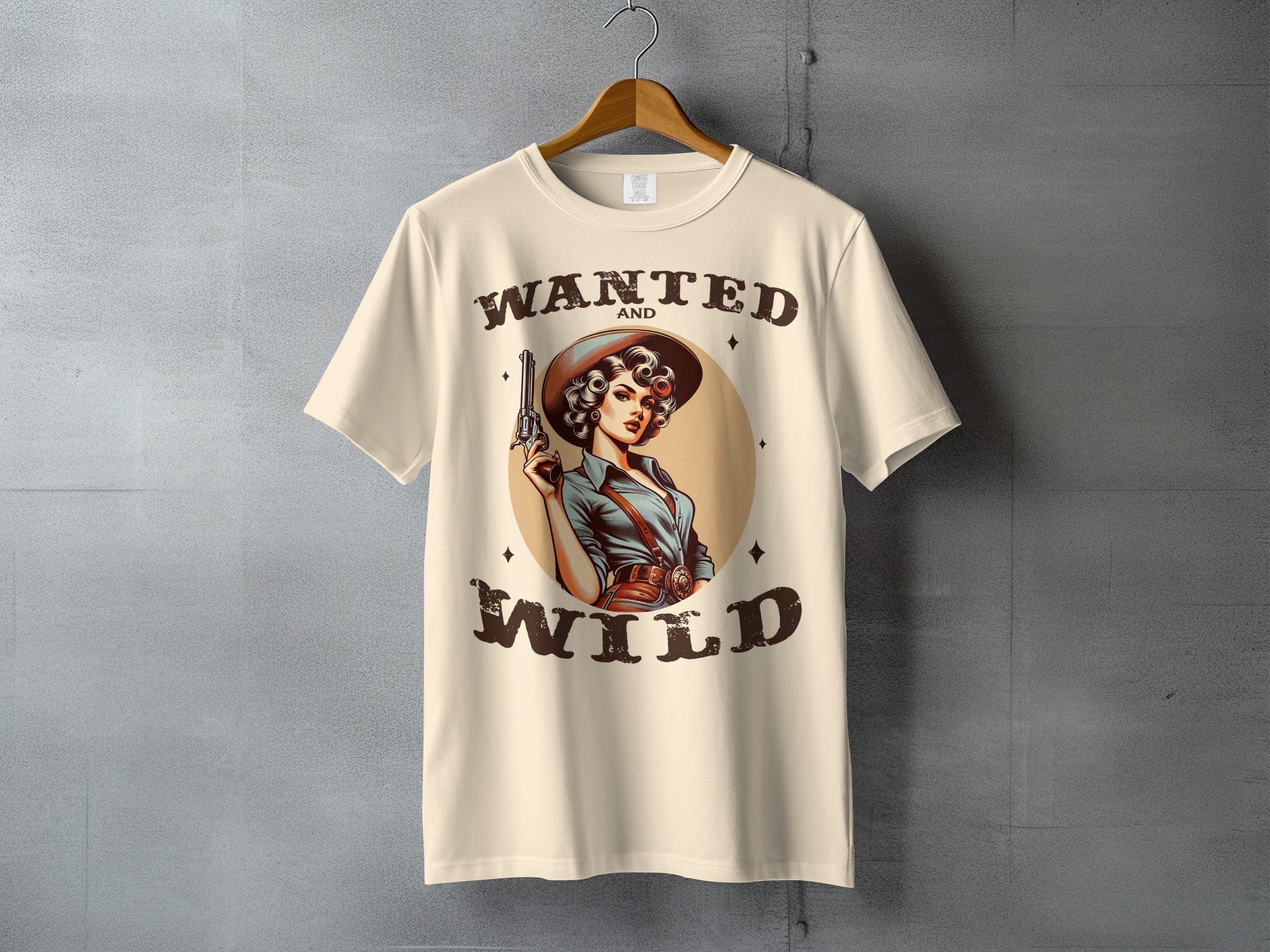 T-shirt with "Wanted and Wild" text and a woman with a gun.