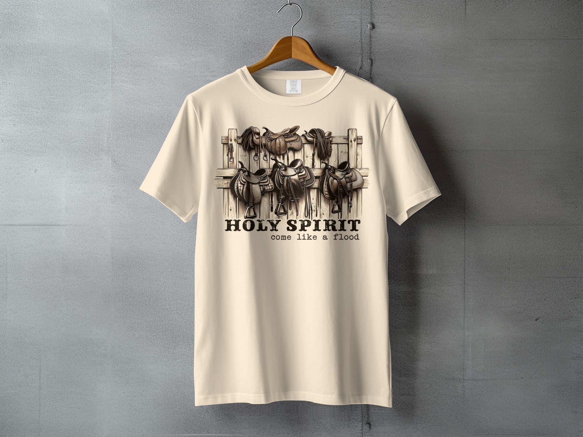 Cream t-shirt with "HOLY SPIRIT come like a flood" and saddle graphic.