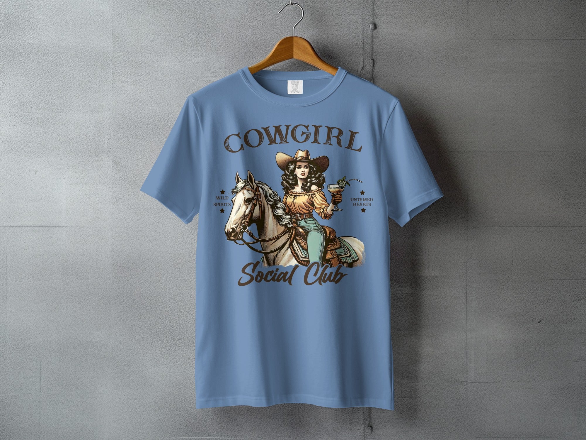 Cowgirl Social Club graphic on a light blue t-shirt.
