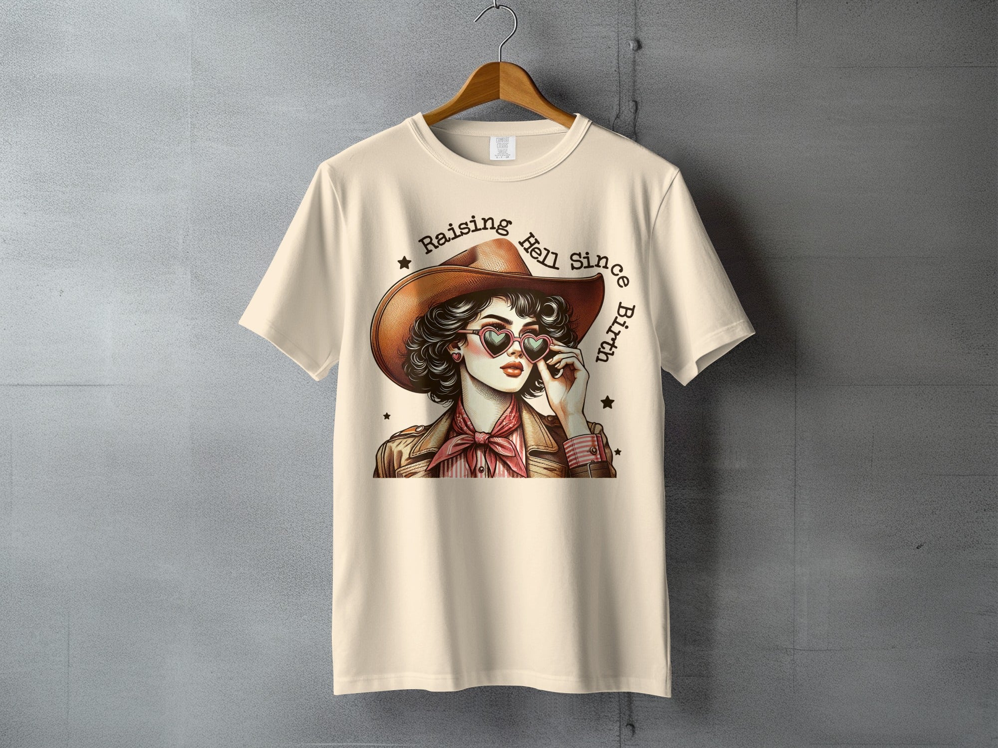 Woman in cowboy hat and heart sunglasses, "Raising Hell Since Birth" text.