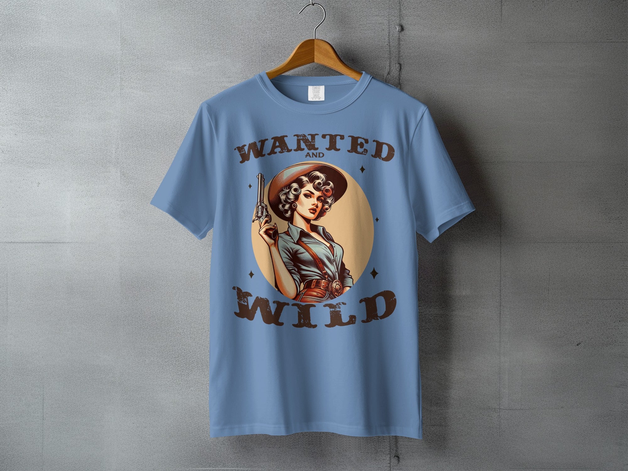 T-shirt with a cowboy woman holding a pistol, "Wanted and Wild" text.