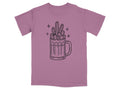 Illustration of cacti in a beer mug with sparkles on a purple t-shirt.