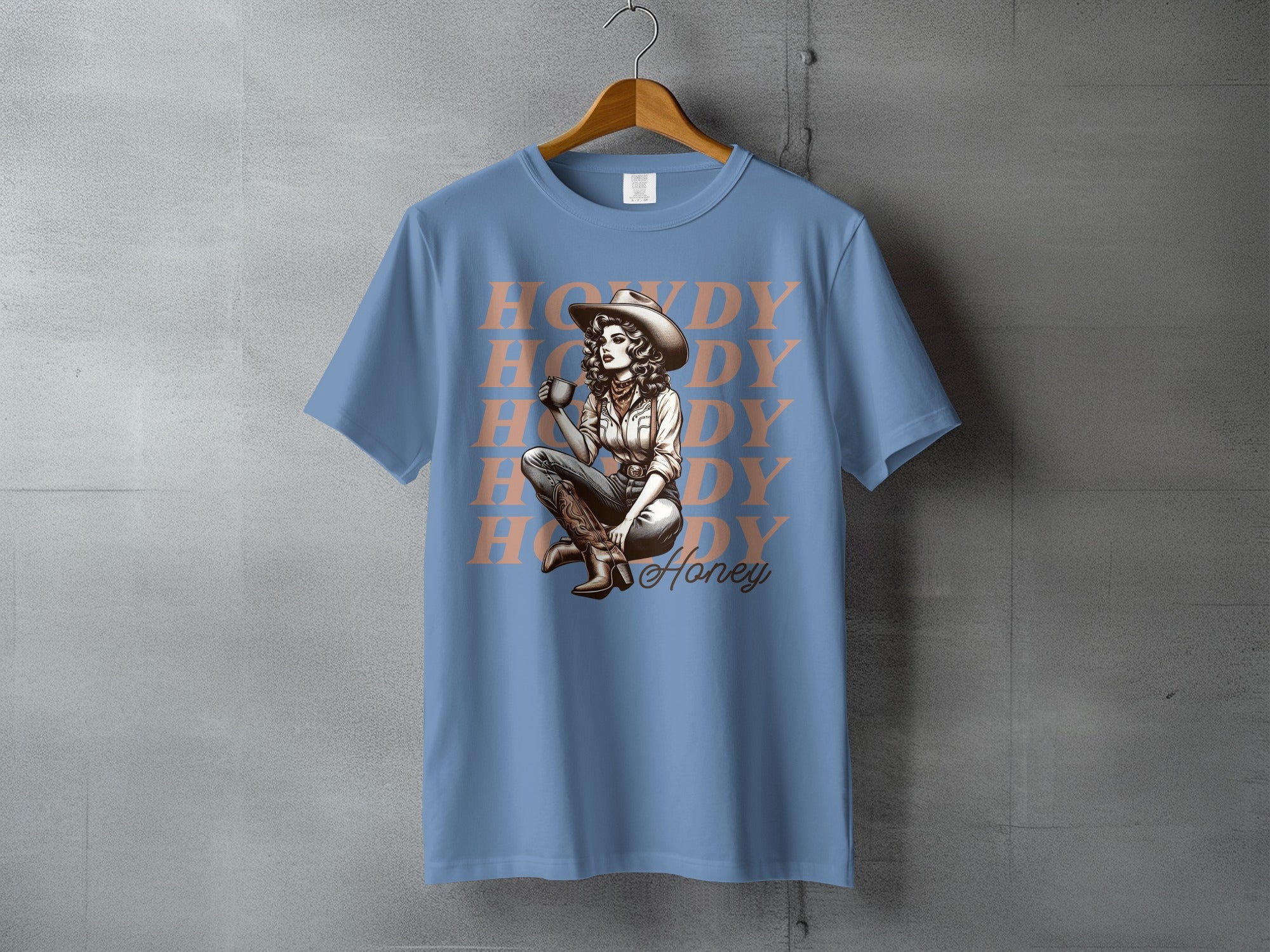 Blue t-shirt with "HNDY DY Honey" text and cowgirl drinking coffee graphic.
